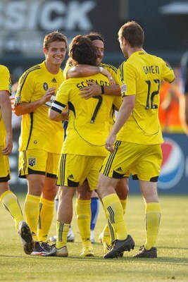 KANSAS CITY - JUNE 6:  Robbie Rogers #19, Gino Padula #4 , Guillermo Barros Schelotto #7 and Eddie Gaven #12 of the Columbus Crew celebrate against the Kansas City Wizards at CommunityAmerica Ballpark on June 6, 2009 in Kansas City, Kansas. (Photo by: Jam