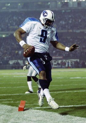 OAKLAND, CA - JANUARY 19:  Quarterback Steve McNair #9 of the Tennessee Titans scores in the third quarter of the AFC Championship game against the Oakland Raiders at Network Associates Coliseum on January 19, 2003 in Oakland, California.  The Raiders def