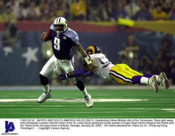 F363722 52: (NORTH AND SOUTH AMERICA SALES ONLY) Quarterback Steve McNair (#9) of the Tennessee Titans gets away from linebacker London Fletcher (#59) of the St. Louis Rams during the fourth quarter of Super Bowl XXXIV between the Rams and the Titans at t