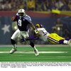 F363722 52: (NORTH AND SOUTH AMERICA SALES ONLY) Quarterback Steve McNair (#9) of the Tennessee Titans gets away from linebacker London Fletcher (#59) of the St. Louis Rams during the fourth quarter of Super Bowl XXXIV between the Rams and the Titans at t