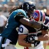 JACKSONVILLE, FL - SEPTEMBER 14:  Derek Schouman #80 of the Buffalo Bills is tackled by Mike Peterson #54 of the Jacksonville Jaguars at Jacksonville Municipal Stadium on September 14, 2008 in Jacksonville, Florida.  (Photo by Sam Greenwood/Getty Images)