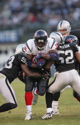 OAKLAND, CA - DECEMBER 3:  Linebackers Kirk Morrison #52 and Thomas Howard #53 of the Oakland Raiders grab a hold of Houston Texans running back Ron Dayne #36 during their game on December 3, 2006 at McAfee Coliseum in Oakland, California.  (Photo by Step