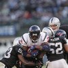 OAKLAND, CA - DECEMBER 3:  Linebackers Kirk Morrison #52 and Thomas Howard #53 of the Oakland Raiders grab a hold of Houston Texans running back Ron Dayne #36 during their game on December 3, 2006 at McAfee Coliseum in Oakland, California.  (Photo by Step