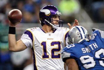 DETROIT - DECEMBER 07:  Quarterback Gus Frerotte #12 of the Minnesota Vikings drops back to pass under pressure from Corey Smith #93 of the Detroit Lions during the NFL game at Ford Field on December 7, 2008 in Detroit, Michigan.  (Photo by Christian Pete