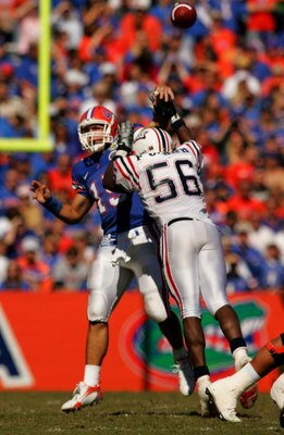 GAINESVILLE, FL - NOVEMBER 17:  Tim Tebow #15 of the Florida Gators throws a pass under pressure from Frantz Joseph #56 of the FAU Owls at Ben Hill Griffin Stadium on November 17, 2007 in Gainesville, Florida.  The Gators won the game 59-20.  (Photo by Sa