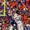 GAINESVILLE, FL - NOVEMBER 17:  Tim Tebow #15 of the Florida Gators throws a pass under pressure from Frantz Joseph #56 of the FAU Owls at Ben Hill Griffin Stadium on November 17, 2007 in Gainesville, Florida.  The Gators won the game 59-20.  (Photo by Sa