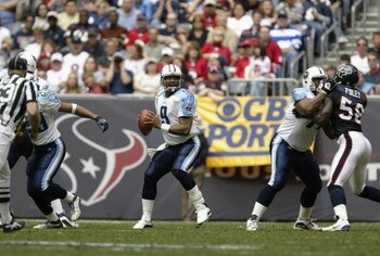 HOUSTON - DECEMBER 21:  Quarterback Steve McNair #9 of the Tennessee Titans looks to throw the ball downfield during the game against the Houston Texans on December 21, 2003 at Reliant Stadium in Houston, Texas.  The Titans won 27-24.   (Photo by Brian Ba