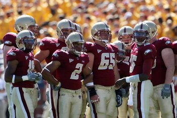 CHESTNUT HILL, MA - SEPTEMBER 20:  Dominique Davis #15 of the Boston College Eagles talks in the huddle against the Central Florida Knights as teammates Matt Tennant #65 and Brandon Robinson #2 stand on September 20, 2008 at Alumni Stadium in Chestnut Hil