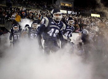 EAST HARTFORD, CT - NOVEMBER 3:  Members of the University of Connecticut Huskies run onto the field against the Rutgers Scarlet Knights at Rentschler Field November 3, 2007 in East Hartford, Connecticut.  (Photo by Jim Rogash/Getty Images)