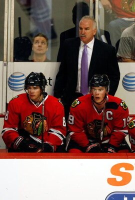 CHICAGO - MAY 24:  Head coach Joel Quenneville of the Chicago Blackhawks stands on the bench behind Patrick Kane #88 and Jonathan Toews #19 against the Detroit Red Wings during Game Four of the Western Conference Championship Round of the 2009 Stanley Cup