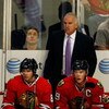 CHICAGO - MAY 24:  Head coach Joel Quenneville of the Chicago Blackhawks stands on the bench behind Patrick Kane #88 and Jonathan Toews #19 against the Detroit Red Wings during Game Four of the Western Conference Championship Round of the 2009 Stanley Cup