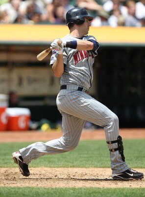 OAKLAND, CA - JUNE 11:  Joe Mauer #7 of the Minnesota Twins bats against the Oakland Athletics during a Major League Baseball game on June 11, 2009 at the Oakland Coliseum in Oakland, California.  (Photo by Jed Jacobsohn/Getty Images)