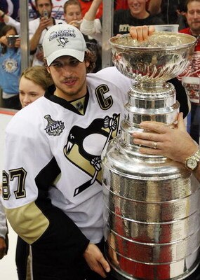 DETROIT - JUNE 12:  Sidney Crosby #87 of the Pittsburgh Penguins celebrates with the Stanley Cup after defeating the Detroit Red Wings by a score of 2-1 to win Game Seven and the 2009 NHL Stanley Cup Finals at Joe Louis Arena on June 12, 2009 in Detroit, 