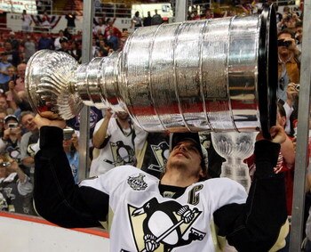 DETROIT - JUNE 12:  Sidney Crosby #87 of the Pittsburgh Penguins celebrates with the Stanley Cup after defeating the Detroit Red Wings by a score of 2-1 to win Game Seven and the 2009 NHL Stanley Cup Finals at Joe Louis Arena on June 12, 2009 in Detroit, 