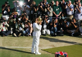 LONDON - JULY 08:  Roger Federer of Switzerland lifts the trophy in front of photographers as he celebrates victory following the Men's Singles final match against Rafael Nadal of Spain during day thirteen of the Wimbledon Lawn Tennis Championships at the