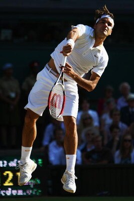 WIMBLEDON, ENGLAND - JULY 05:  Roger Federer of Switzerland serves during the men's singles final match against Andy Roddick of USA on Day Thirteen of the Wimbledon Lawn Tennis Championships at the All England Lawn Tennis and Croquet Club on July 5, 2009 