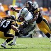 PITTSBURGH - SEPTEMBER 12:  Justin Fargas #20 of the Oakland Raiders runs with the ball while tackled by  Troy Polamalu #43 and Larry Foote #50 of the Pittsburgh Steelers on September 12, 2004 at Heinz Field in Pittsburgh, Pennsylvania. The Steelers won 2