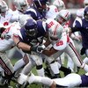 EVANSTON, IL - NOVEMBER 08:  Stephan Simmons #25 of the Northwestern Wildcats is tackled by Shaun Lane #29 and Austin Spitler #38 of the Ohio State Buckeyes at Ryan Stadium on November 8, 2008 in Evanston, Illinois  (Photo by Jonathan Ferrey/Getty Images)