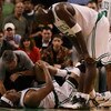 BOSTON - DECEMBER 15:  Paul Pierce #34 of the Boston Celtics is looked after by Ed Lecerte and teammate Kevin Garnett #5 after Pierce injured his knee late in the fourth quarter against the Utah Jazz on December 15, 2008 at TD Banknorth Garden in Boston, 