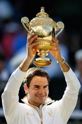 WIMBLEDON, ENGLAND - JULY 05: Roger Federer of Switzerland celebrates victory with the trophy after the men's singles final match against Andy Roddick of USA on Day Thirteen of the Wimbledon Lawn Tennis Championships at the All England Lawn Tennis and Cr