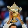 WIMBLEDON, ENGLAND - JULY 05:  Roger Federer of Switzerland celebrates victory with the trophy after the men's singles final match against Andy Roddick of USA on Day Thirteen of the Wimbledon Lawn Tennis Championships at the All England Lawn Tennis and Cr
