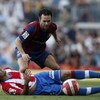 BARCELONA, SPAIN - OCTOBER 07: Andres Iniesta (R) of Barcelona challenges a fallen Jose Antonio Reyes of Atletico de Madrid during the Primera Liga match between Barcelona and Atletico de Madrid at the Camp Nou stadium on October 7, 2007 in Barcelona, Spa