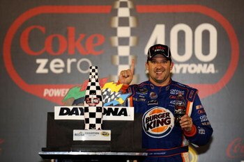 DAYTONA BEACH, FL - JULY 04: Tony Stewart, driver of the #14 Burger King Chevrolet, celebrates in victory lane after winning the NASCAR Sprint Cup Series 51st Annual Coke Zero 400 at Daytona International Speedway on July 4, 2009 in Daytona Beach, Florida