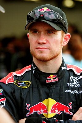 DAYTONA BEACH, FL - JULY 02: Brian Vickers, driver of the #83 Red Bull Toyota, stands in the garage during practice for the NASCAR Sprint Cup Series Coke Zero 400 at Daytona International Speedway on July 2, 2009 in Daytona Beach, Florida.  (Photo by Jerr