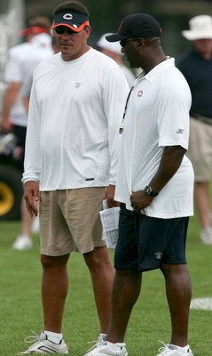 BOURBONNAIS, IL - JULY 27: Defensive coordinator Ron Rivera (L) and head coach Lovie Smith of the Chicago Bears talk during the first summer training camp practice on July 27, 2006 at Olivet Nazarene University in Bourbonnais, Illinois. (Photo by Jonathan