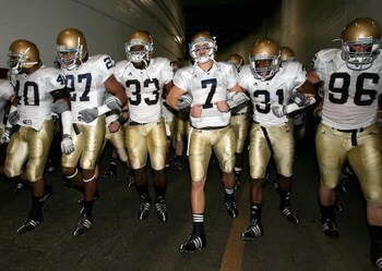 LOS ANGELES, CA - NOVEMBER 29:  Quarterback Jimmy Clausen #7 of the Notre Dame Fighting Irish walks out with teammates Robert Hughes #33 and Sergio Brown #31 before the game against the USC Trojans at Los Angeles Memorial Coliseum on November 29, 2008 in 