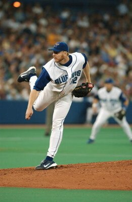 TORONTO - JULY 12:  Pitcher Roy Halladay #32 of the Toronto Blue Jays delivers a pitch during the American League game against the New York Yankees at SkyDome on July 12, 2003 in Toronto, Ontario. The Blue Jays won the game 10-3.  (Photo By Dave Sandford/