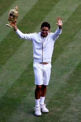 WIMBLEDON, ENGLAND - JULY 05:  Roger Federer of Switzerland celebrates victory with the trophy after the men's singles final match against Andy Roddick of USA on Day Thirteen of the Wimbledon Lawn Tennis Championships at the All England Lawn Tennis and Cr