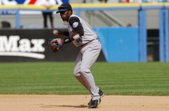 CHICAGO - AUGUST 6:  Angel Berroa #4 of the Kansas City Royals readies to throw the ball to first base against the Chicago White Sox during the game on August 6, 2003 at U.S. Cellular Field in Chicago, Illinois.  The White Sox defeated the Royals 4-3.  (P
