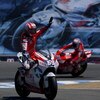 MONTEREY, CA - JULY 5:  Nicky Hayden rider of the #69 Ducati waves to the crowd as his teamate Casey Stoner rides in the background after the Moto GP Red Bull U. S. Grand Prix at the Mazda Raceway Laguna Seca on July 5, 2009 in Monterey, California.  (Pho