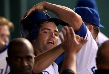 KANSAS CITY, MO - JULY 7:  David DeJesus #9 of the Kansas City Royals is congratulated by teammates in the dugout after scoring during the bottom of the 8th inning of the game against the Tampa Bay Devil Rays at Kaufmann Stadium July 7, 2007 in Kansas Cit
