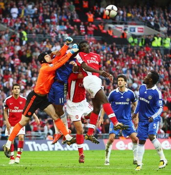 LONDON - APRIL 18:  Petr Cech of Chelsea punches clear from Kolo Toure of Arsenal during the FA Cup sponsored by E.ON Semi Final match between Arsenal and Chelsea at Wembley Stadium on April 18, 2009 in London, England.  (Photo by Phil Cole/Getty Images)