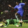 MANCHESTER, UNITED KINGDOM - NOVEMBER 26: Edwin van der Sar of Manchester United dives at the feet of Didier Drogba of Chelsea during the Barclays Premiership match between Manchester United and Chelsea at Old Trafford on November 26, 2006 in Manchester, 