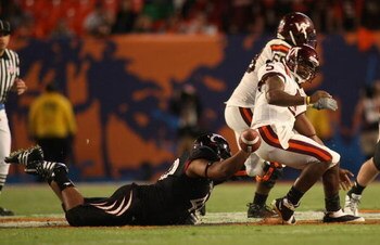 MIAMI - JANUARY 01:  John Hughes # 40 of the Cincinnati Bearcats tackles Tyrod Taylor #5 of the Virginia Tech Hokies as he loses the ball during the FedEx Orange Bowl at Dolphin Stadium on January 1, 2009 in Miami, Florida.  (Photo by Marc Serota/Getty Im