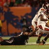 MIAMI - JANUARY 01:  John Hughes # 40 of the Cincinnati Bearcats tackles Tyrod Taylor #5 of the Virginia Tech Hokies as he loses the ball during the FedEx Orange Bowl at Dolphin Stadium on January 1, 2009 in Miami, Florida.  (Photo by Marc Serota/Getty Im