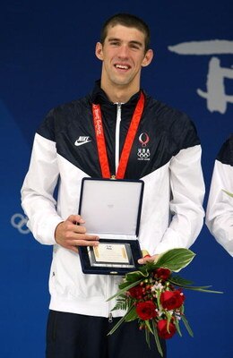 BEIJING - AUGUST 17:  Michael Phelps of the United States hold his award from FINA after receiving his gold medal at the medal ceremony for the Men's 4x100 Medley Relay at the National Aquatics Centre during Day 9 of the Beijing 2008 Olympic Games on Augu