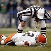 SEATTLE - NOVEMBER 30:  Referee Ed Hochuli #85 looks to help Quarterback Tim Couch #2 of the Cleveland Browns as he lays hurt during the game against the Seattle Seahawks on November 30 2003 at Seahawks Stadium in Seattle, Washington. The Seahawks defeate