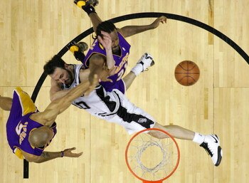 SAN ANTONIO - MAY 25:  Manu Ginobili #20 of the San Antonio Spurs goes up for a shot as he is fouled by Derek Fisher #2 of the Los Angeles Lakers in Game Three of the Western Conference Finals during the 2008 NBA Playoffs on May 25, 2008 at the AT&T Cente