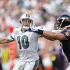MIAMI - JANUARY 4:  Chad Pennington #10 of the Miami Dolphins scrambles against Jarret Johnson #95 of the Baltimore Ravens during a AFC Wild Card playoff game on January 4, 2009 at Dolphin Stadium in Miami, Florida. (Photo by Gregory Shamus/Getty Images)