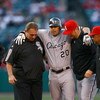 ANAHEIM, CA - MAY 25:  Carlos Quentin #20 of the Chicago White Sox is helped off the field after hitting a double and sustaining an injury in the first inning against the Los Angeles Angels of Anaheim at Angel Stadium on May 25, 2009 in Anaheim, Californi
