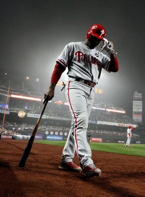 NEW YORK - JUNE 11: Jimmy Rollins #11 of the Philadelphia Phillies on deck to bat against the New York Mets on June 11, 2009 at Citi Field in the Flushing neighborhood of the Queens borough of New York City. (Photo by Nick Laham/Getty Images)
