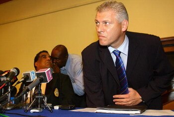 KINGSTON, JAMAICA - MARCH 22:  Deputy Chief of Police for Jamaica Mark Shields (R) sits down alongside ICC Police Director of Communications Carl Angell to talk to the media during a press conference to confirm that a murder investigation is now under way