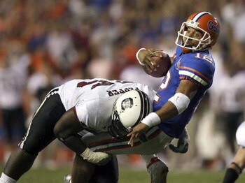 GAINESVILLE, FL - NOVEMBER 11:  Defensive tackle Nathan Pepper #95 of the South Carolina Gamecocks brings down quarterback Chris Leak #12 of the University of Florida Gators on a first down run to set up a touchdown in the fourth quarter on November 11, 2