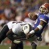 GAINESVILLE, FL - NOVEMBER 11:  Defensive tackle Nathan Pepper #95 of the South Carolina Gamecocks brings down quarterback Chris Leak #12 of the University of Florida Gators on a first down run to set up a touchdown in the fourth quarter on November 11, 2