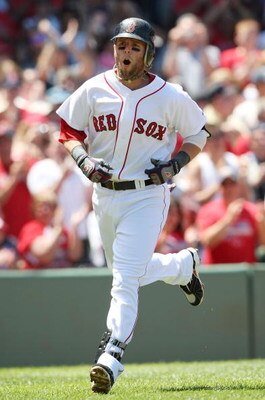 BOSTON - JULY 05:  Dustin Pedroia #15 of the Boston Red Sox celebrates his solo home run in the first inning against the Seattle Mariners on July 5, 2009 at Fenway Park in Boston, Massachusetts.  (Photo by Elsa/Getty Images)