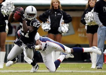 OAKLAND, CA - NOVEMBER 12:  Fabian Washington #27 of the Oakland Raiders makes a reception against pressure from Rod Smith #80 of the Denver Broncos during an NFL game at McAfee Coliseum on November 12, 2006 in Oakland, California.  (Photo by Jed Jacobsoh